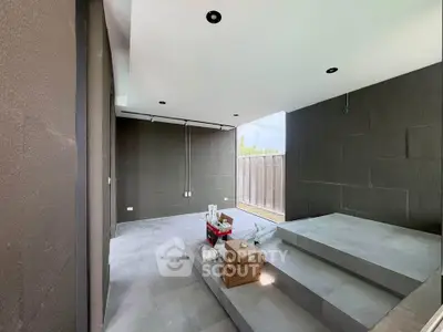Modern minimalist interior with sleek gray flooring and open layout, ideal for contemporary living.