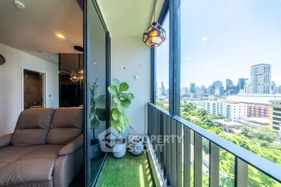Stunning city view from modern balcony with cozy seating and lush greenery.