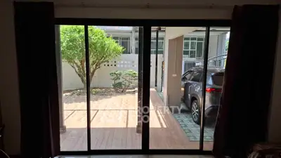 Spacious home with sliding glass doors leading to a carport and garden area.
