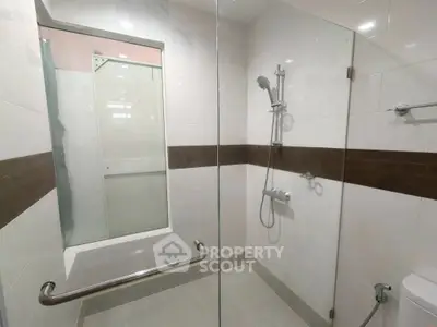 Modern bathroom with glass shower and sleek tile design