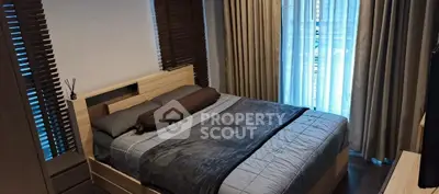 Cozy bedroom with modern decor and large window for natural light