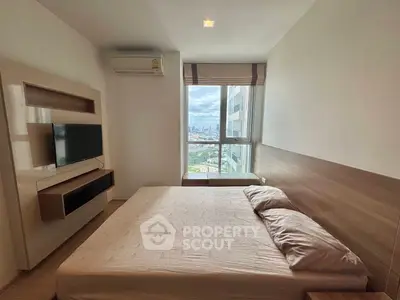 Modern bedroom with city view, featuring a wall-mounted TV and air conditioning.