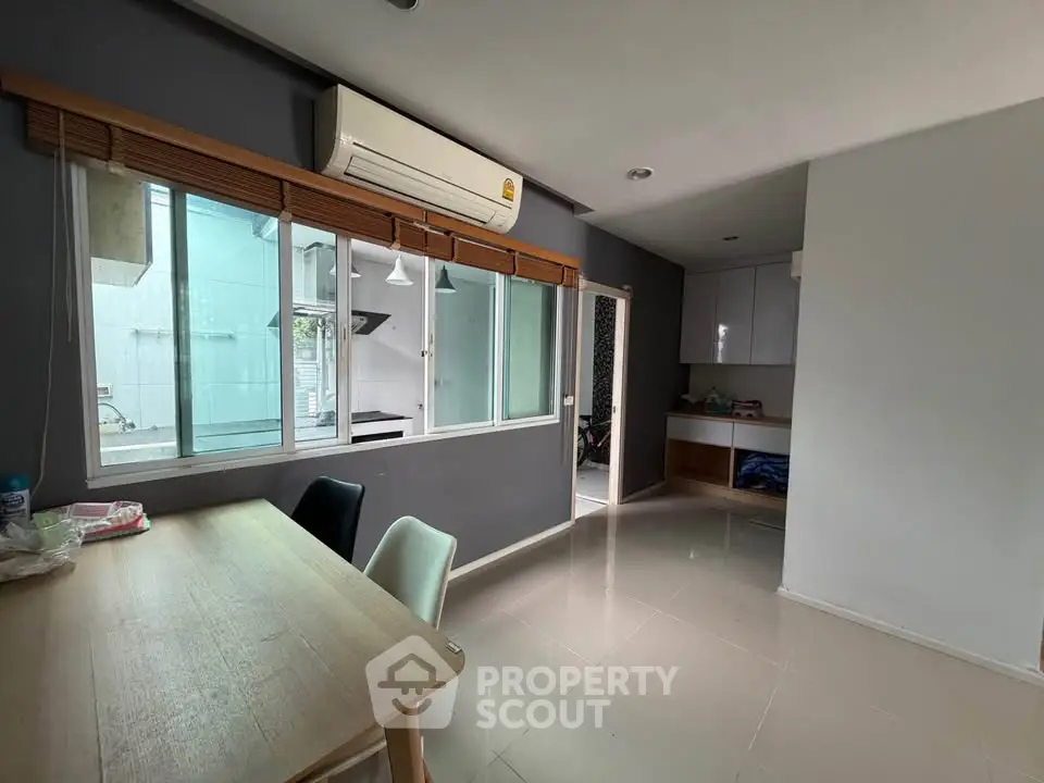 Modern dining area with air conditioning and large window in a stylish apartment.