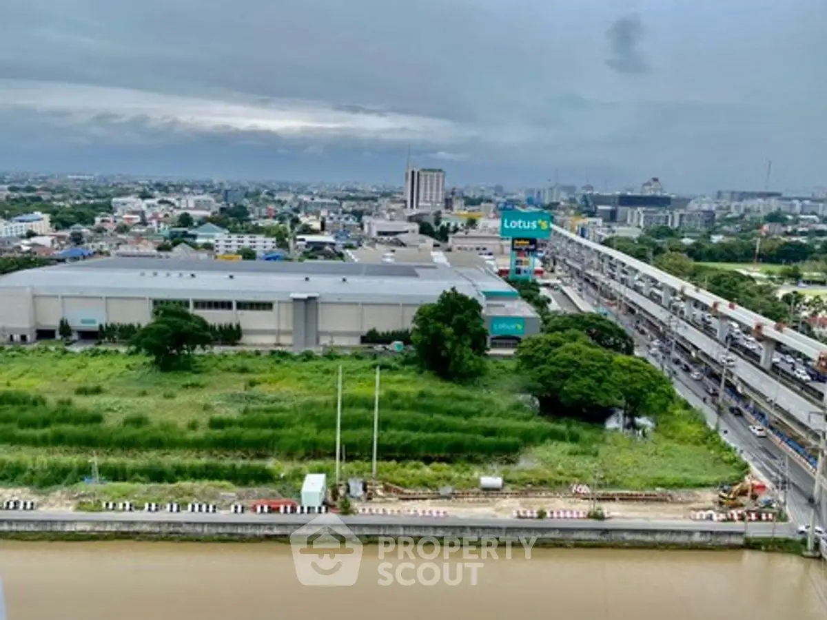 Panoramic cityscape view with lush greenery and urban skyline, showcasing potential real estate development.
