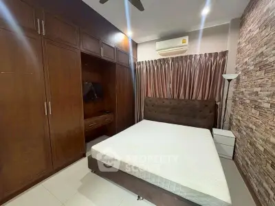 Spacious bedroom with built-in wardrobe and modern decor