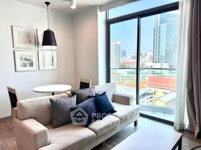 Modern living room with city view, stylish decor, and natural light.