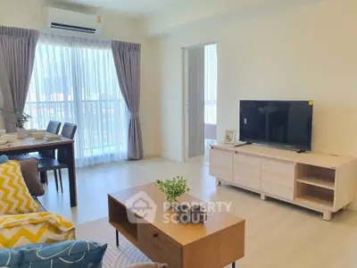 Bright and modern living room with stylish furniture and large windows in a contemporary apartment.