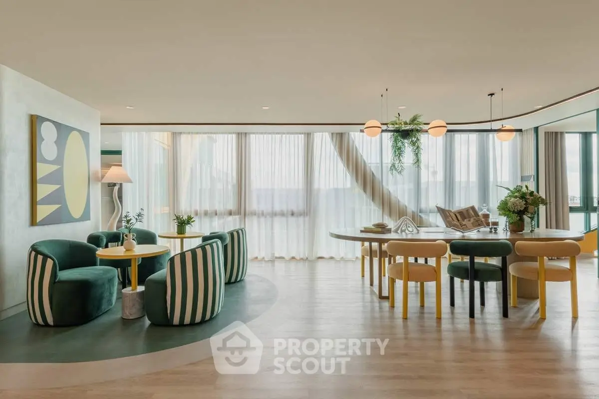 Luxurious modern living room with stylish furniture and panoramic windows offering stunning views.