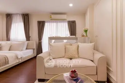 Cozy living room with elegant decor and natural light in modern apartment.