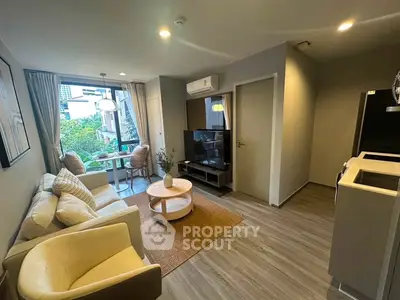 Modern living room with stylish furniture and large window offering a garden view, perfect for urban living.