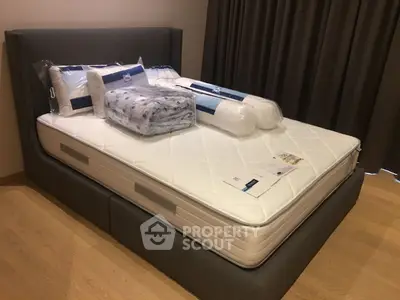 Luxurious bedroom with plush mattress and elegant bedding in modern apartment.