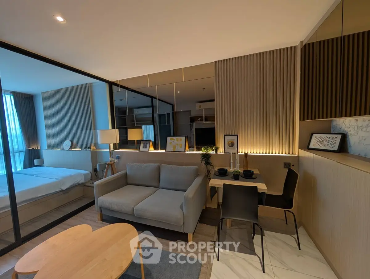 Modern open-plan living room with cozy sofa and dining area in stylish apartment