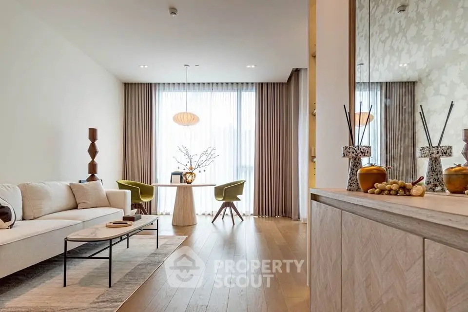 Elegant living room with modern decor, large windows, and stylish furniture in a contemporary apartment.