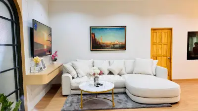 Elegant living room with modern decor, featuring a cozy sectional sofa and stylish wall art.