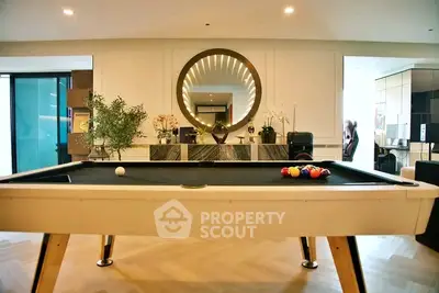 Luxurious living room with pool table and elegant decor, perfect for entertainment and relaxation.
