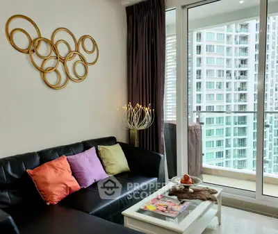 Modern living room with stylish decor and balcony view in high-rise apartment