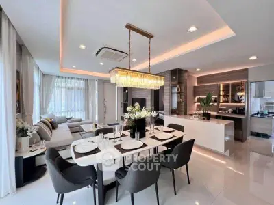 Luxurious open-plan living and dining area with modern kitchen and elegant decor.