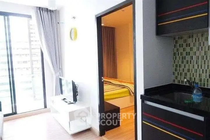 Modern apartment interior with open layout, featuring a cozy living area and stylish kitchen.