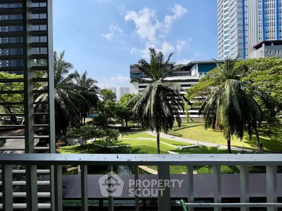 Stunning garden view from a modern balcony in a high-rise building, perfect for relaxation and urban living.