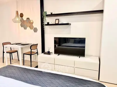 Modern living room with sleek TV setup and stylish dining area