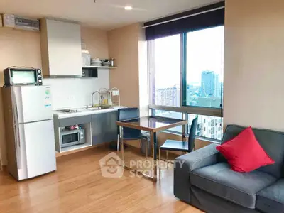 Modern apartment interior with kitchen and living area, featuring city view.