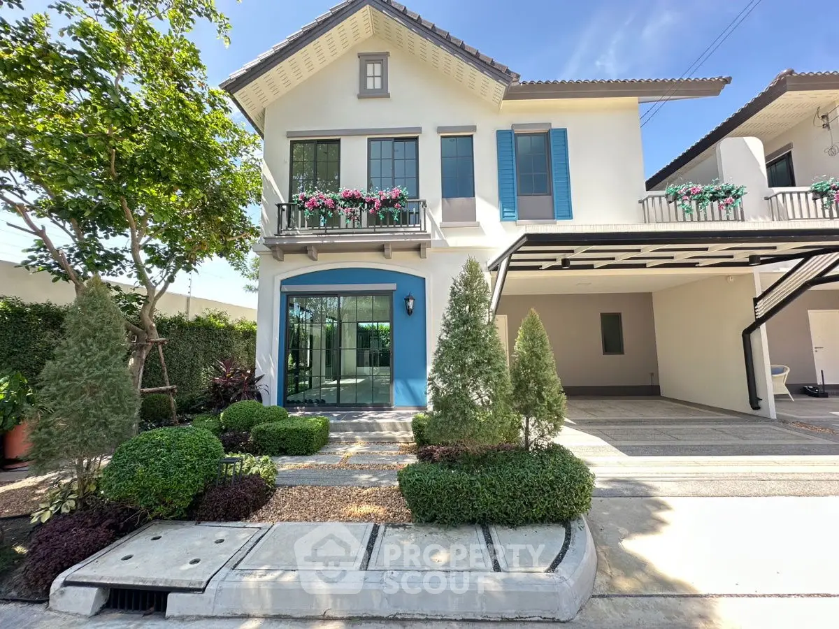 Charming two-story house with lush garden and spacious carport in a serene neighborhood.