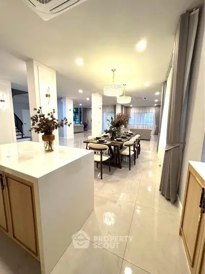 Luxurious open-plan dining area with elegant lighting and modern decor