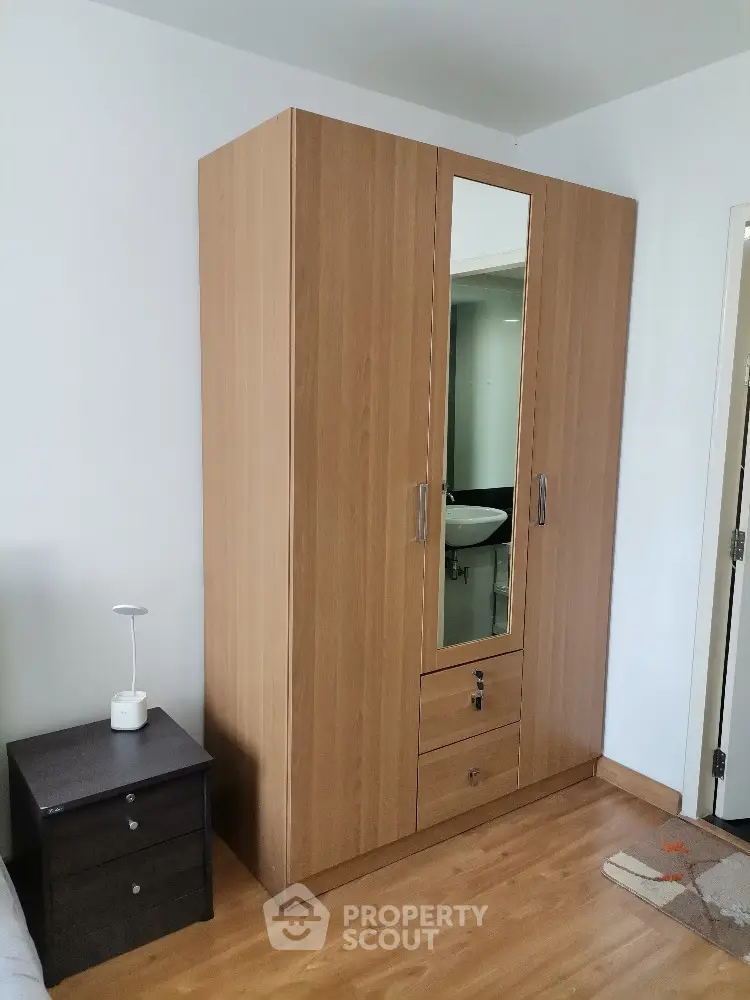 Spacious bedroom with wooden wardrobe and modern decor