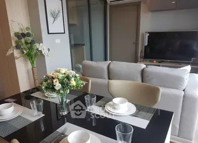 Modern living room with elegant dining setup and cozy sofa, perfect for stylish urban living.
