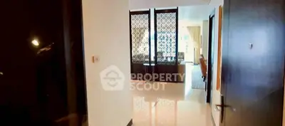 Spacious modern apartment entrance with elegant decor and open layout.