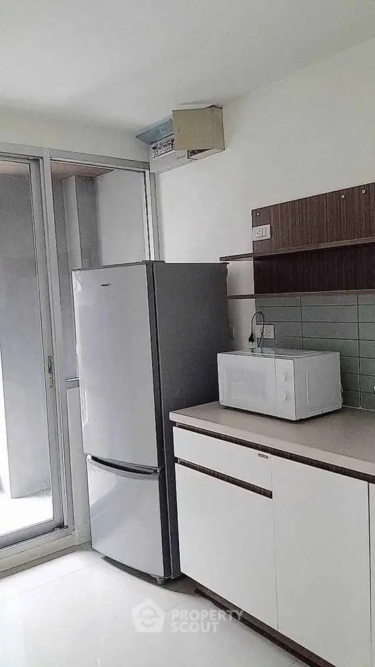 Modern kitchen with sleek appliances and ample natural light