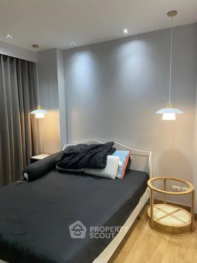 Modern bedroom with stylish lighting and cozy decor, perfect for relaxation and comfort.