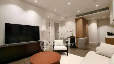 Modern living room with sleek furniture and ambient lighting, perfect for relaxation and entertainment.