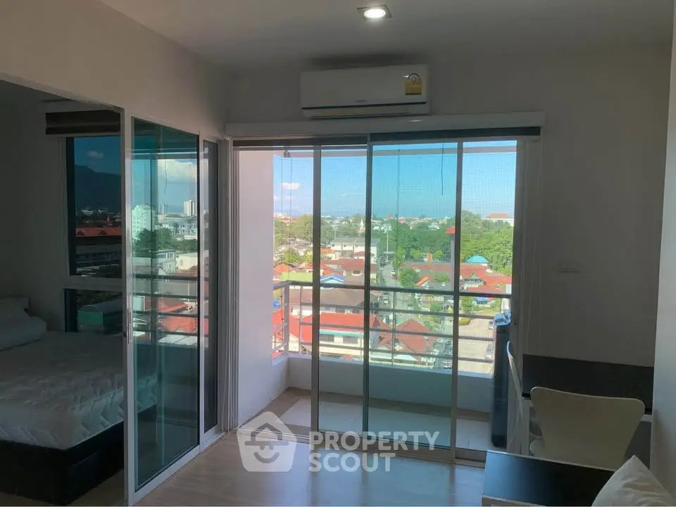 Modern apartment with balcony offering stunning city views and ample natural light.
