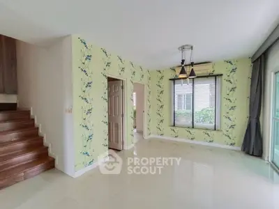 Spacious living room with elegant wallpaper and natural light