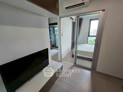 Modern apartment interior with sleek design, featuring a cozy bedroom and living area with air conditioning.