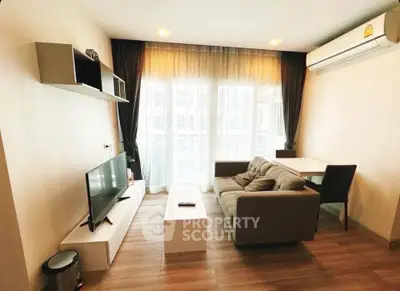 Modern living room with cozy sofa, TV, and air conditioning in bright apartment.