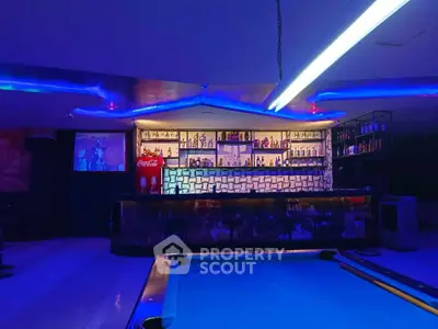 Modern bar interior with ambient lighting and pool table, perfect for entertainment and leisure.