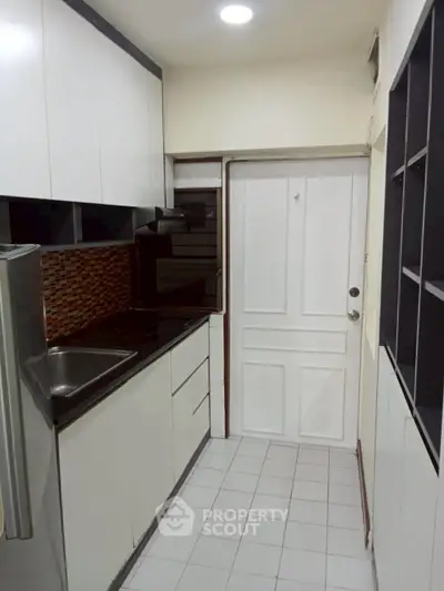 Compact kitchen with modern cabinetry and tiled backsplash