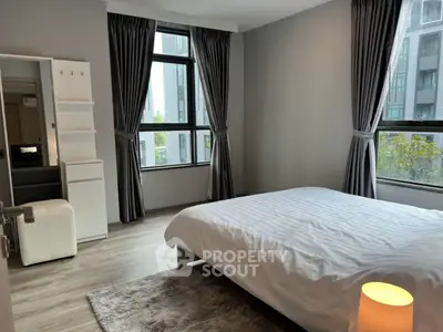 Modern bedroom with large windows and stylish decor in urban apartment