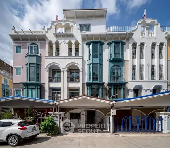 Charming multi-story building with unique architectural design and vibrant colors.