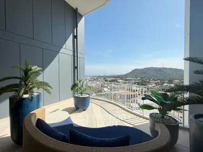 Luxurious balcony with stunning panoramic view and stylish outdoor seating.