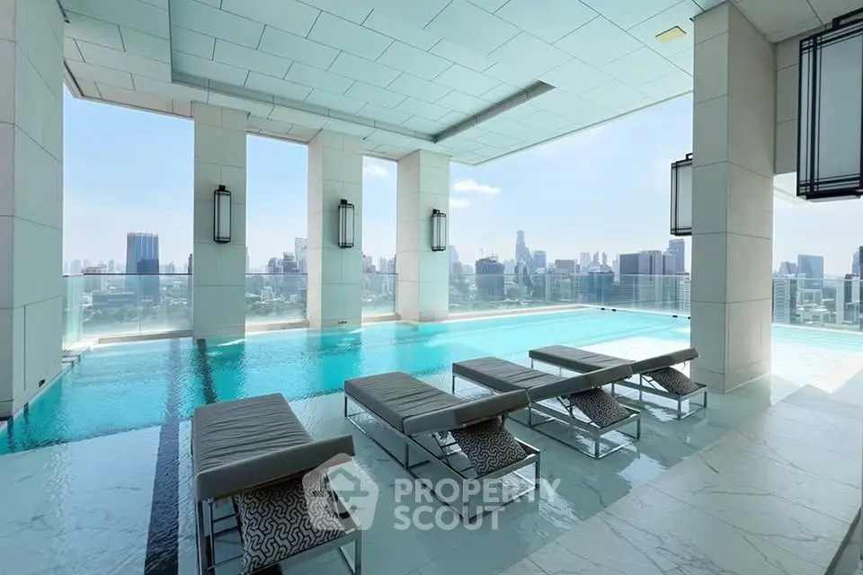 Luxurious rooftop pool with stunning city skyline views and modern lounge chairs.