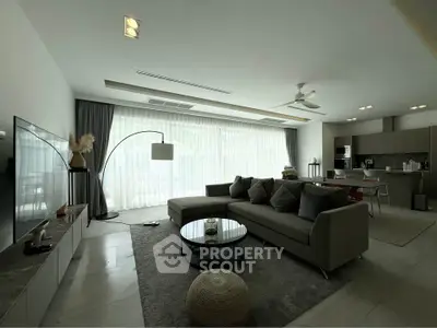 Spacious modern living room with large windows and elegant decor