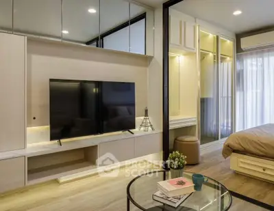Modern living room with sleek TV unit and cozy bedroom view