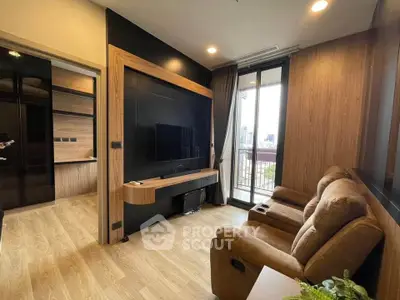 Modern living room with balcony view and cozy seating in stylish apartment.