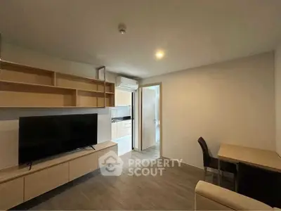 Modern living room with sleek TV unit and open kitchen layout