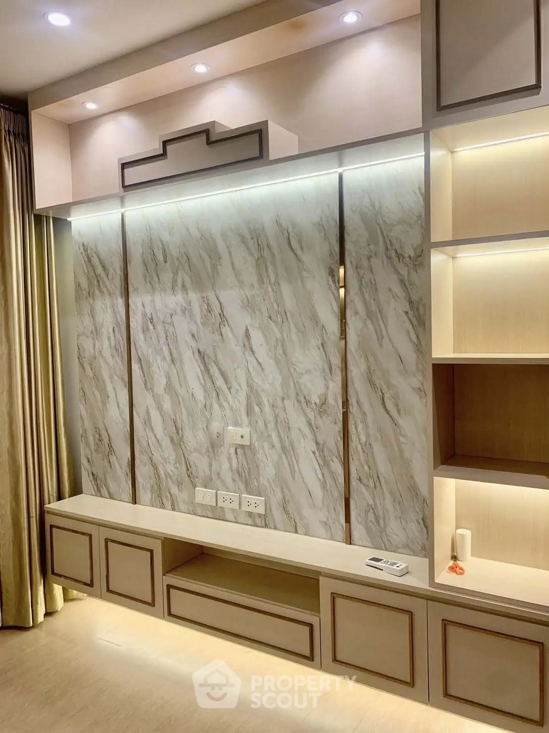 Elegant living room with modern built-in shelving and marble accent wall