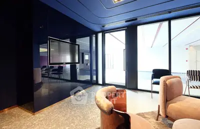 Modern living room with sleek design and large windows in luxury apartment.