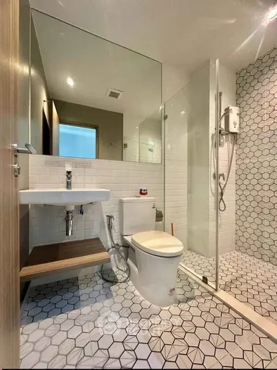 Modern bathroom with hexagonal tiles and glass shower enclosure